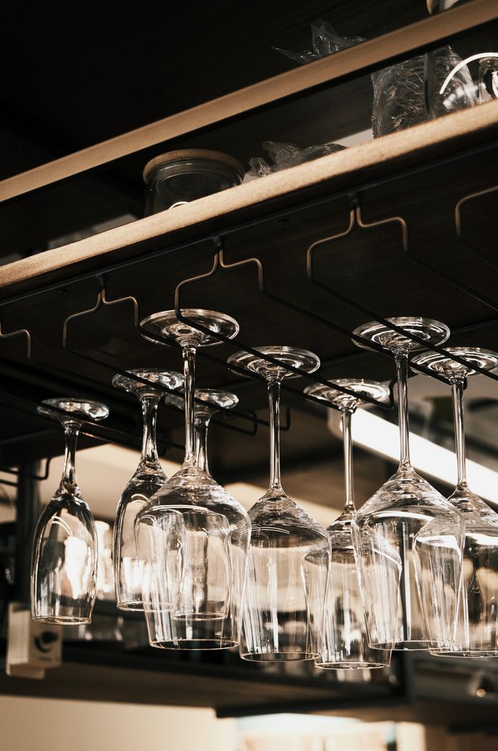 Chic display of hanging wine glasses in an upscale restaurant bar.